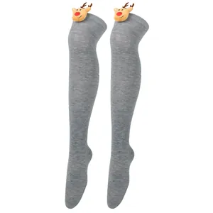 Close-up detail of gray over-the-knee Christmas socks with plush reindeer