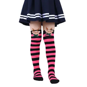 Close-up of pink and black striped Christmas socks with cute 3D plush reindeer dolls.