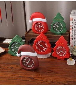 Detailed view of creative cartoon Christmas tree and Santa hat clocks on a wooden desk