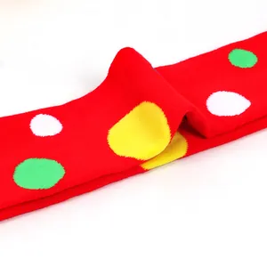 Macro view of red over-the-knee socks with colorful large polka dots texture