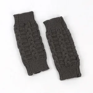 Close-up of dark grey cable knit texture on warm fingerless winter gloves