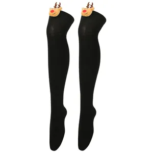 Close-up detail of black over-the-knee stockings with plush reindeer decorations