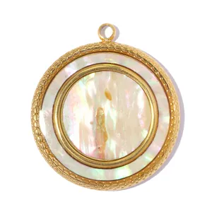 Macro view of round gold-plated stainless steel pendant with iridescent white shell inlay