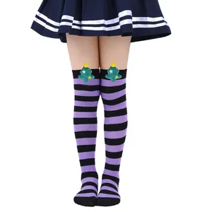 Purple and black striped over-the-knee socks with green plush Christmas tree detail