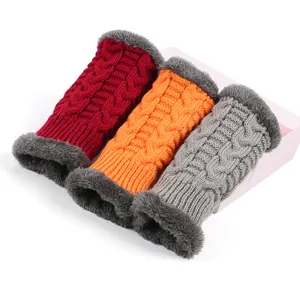 Detail view of thick knitted arm warmers with soft faux fur lining in multiple colors.