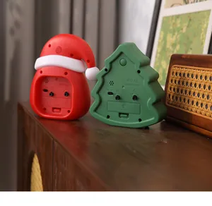 Detailed back view of Christmas tree and Santa hat alarm clocks showing controls.