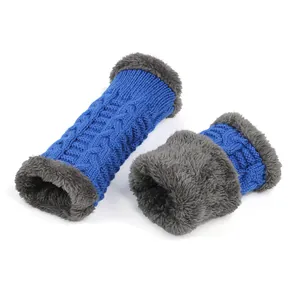 Close-up of blue knitted arm warmers with thick grey faux fur lining for winter warmth.