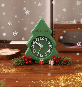 Festive Christmas tree-shaped green alarm clock placed on a decorated wooden table