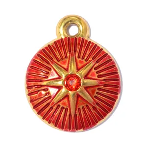 Close-up of stainless steel starburst pendant with red enamel and central rhinestone