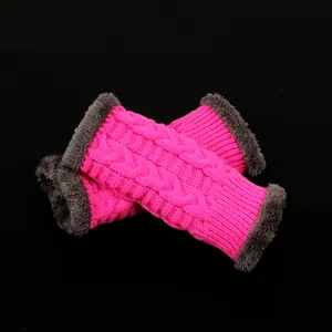 Macro view of pink cable knit winter arm warmers featuring soft grey faux fur trim details.
