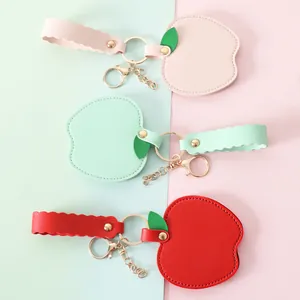 Set of apple-shaped PU leather mirror keychains in pink, green, and red colors.