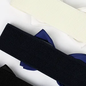 Close-up macro details of wide elastic belts featuring elegant chiffon bows in various colors