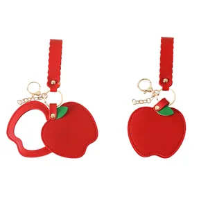 Red apple shaped PU leather keychain with built-in compact mirror and gold hardware