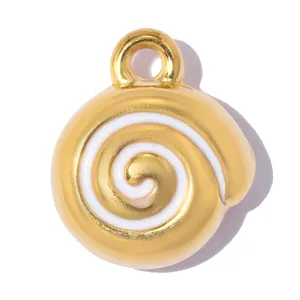 Close-up of gold spiral pendant charm with white enamel detail for DIY jewelry.