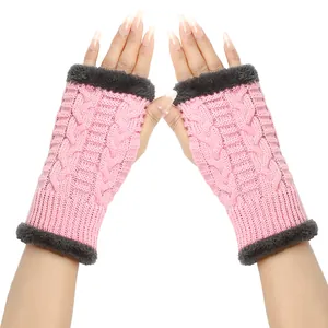 Macro view of pink cable-knit fingerless gloves with soft grey faux fur trim detail
