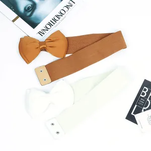 Close-up of elastic waist belts with elegant chiffon bow and snap button closure