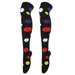 Close-up of black over-the-knee socks featuring colorful polka dot patterns
