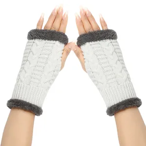 Detailed view of white cable knit fingerless gloves with soft grey faux fur trim border.