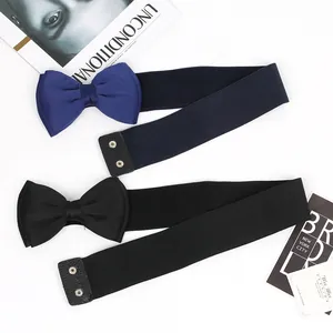 Detail view of wide elastic belts with large chiffon bow knots in navy and black.