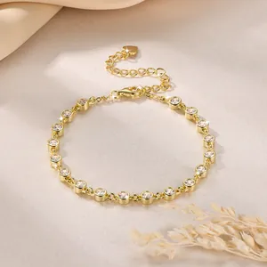 Close-up of elegant gold bezel-set cubic zirconia bracelet with heart charm