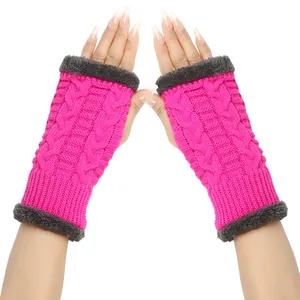 Close-up of pink cable-knit fingerless gloves with grey plush trim for autumn and winter warmth