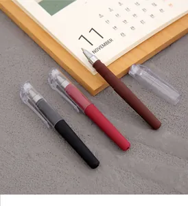 Detailed view of three mini portable gel pens in black, red, and brown colors on desk