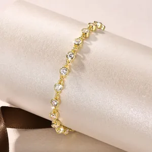 Detail view of a gold-tone bubble bracelet featuring sparkling 5A round zircons