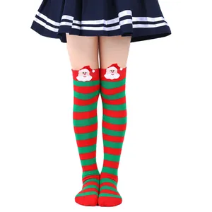 Detailed view of children's Christmas over-the-knee socks with 3D Santa Claus dolls.