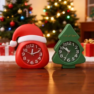 Festive Christmas tree and Santa hat shaped alarm clocks in warm holiday setting