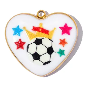 Close-up detail of heart-shaped soccer ball pendant with golden crown and colorful stars