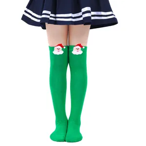 Detailed view of green over-the-knee Christmas socks for girls with 3D Santa plush