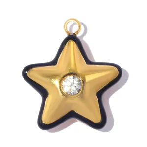 Detailed macro view of a gold star pendant with black enamel edge and center crystal