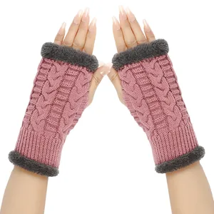 Detail view of pink cable-knit fingerless gloves with grey faux fur trim on hands
