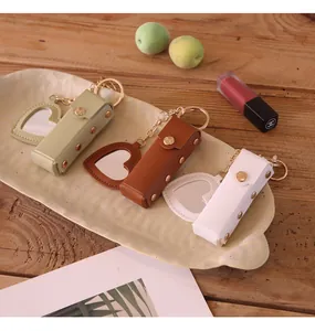Portable heart-shaped leather lipstick cases in three colors with built-in mirrors and keychains