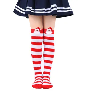 Detailed view of child's red and white striped socks with plush Santa decoration