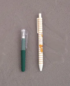 Detailed close-up showing a short dark green gel pen and a white striped portable pen