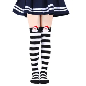 Detail showing children's Christmas over-the-knee socks with 3D Santa Claus plush doll