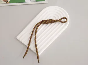 Durable contrast color nylon lanyard for phone or keys displayed on a white tray