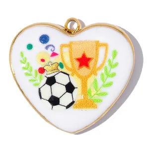 Heart-shaped stainless steel pendant featuring a colorful soccer ball and trophy graphic