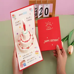Detail showing 3D pop-up birthday cake and elegant red greeting card cover