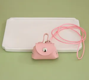 Close-up detail of a stylish pink mini PU leather lanyard pouch for coins or earphones.