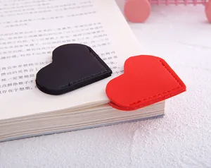 Detailed close-up of red and black heart-shaped PU leather bookmarks protecting book corners