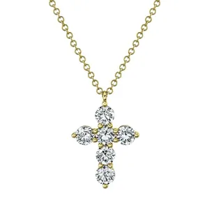 Close-up of elegant gold-toned cross pendant necklace set with six round Moissanite stones