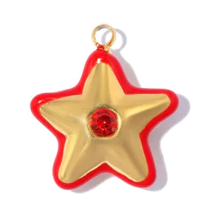 Close-up of a gold star pendant with red oil drip edge and a central ruby crystal