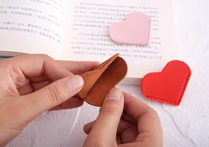 Detailed view of heart-shaped PU leather bookmark used as a page corner protector