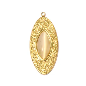Detailed view of a vintage gold oval pendant with textured finish and cat's eye stone