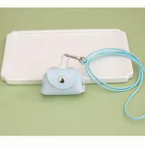 Close-up of a mini light blue PU leather coin pouch with a matching neck lanyard strap.