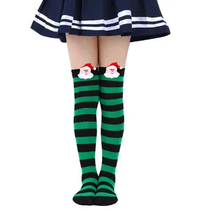 Close-up of children's striped Christmas socks with Santa Claus doll decoration