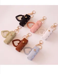 Detailed view of portable leather lipstick pouches with heart mirrors in multiple colors.