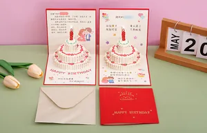 Detailed view of the 3D pop-up birthday cake card with cute couple artwork and envelope